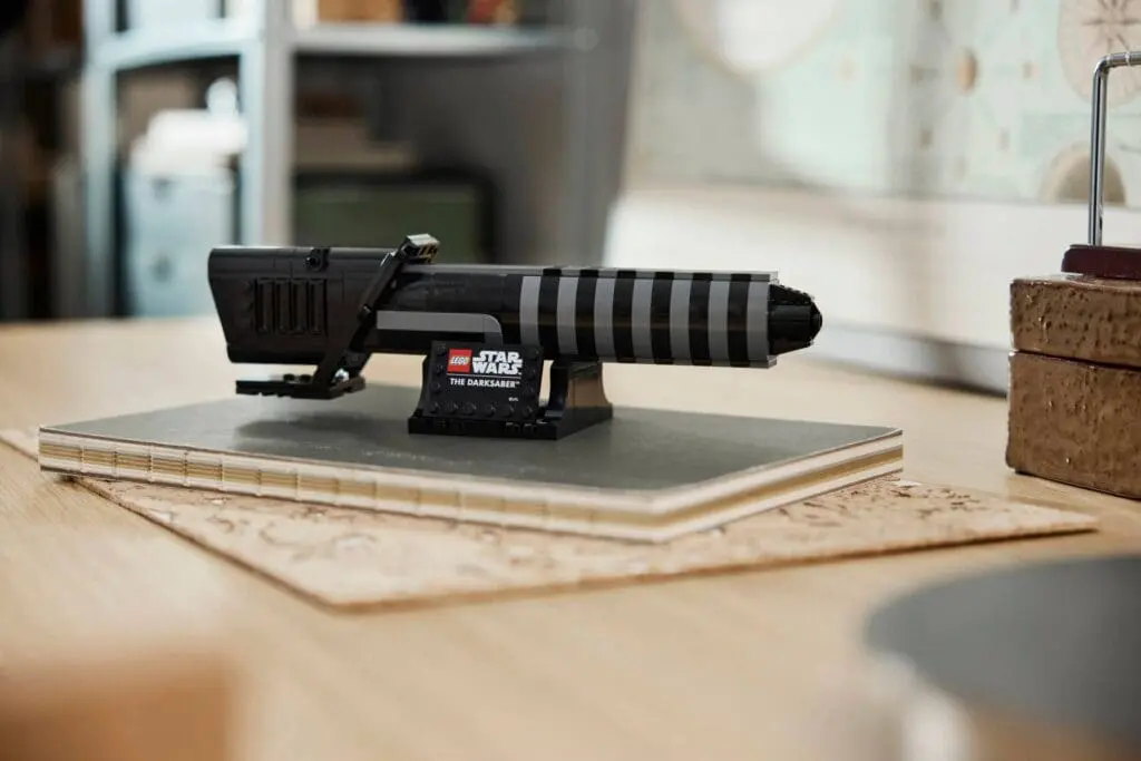 LEGO Star Wars lightsaber model on table.