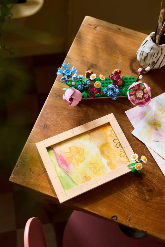 Creative desk with flowers and painting