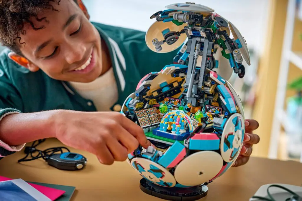 Smiling kid assembling detailed LEGO creation