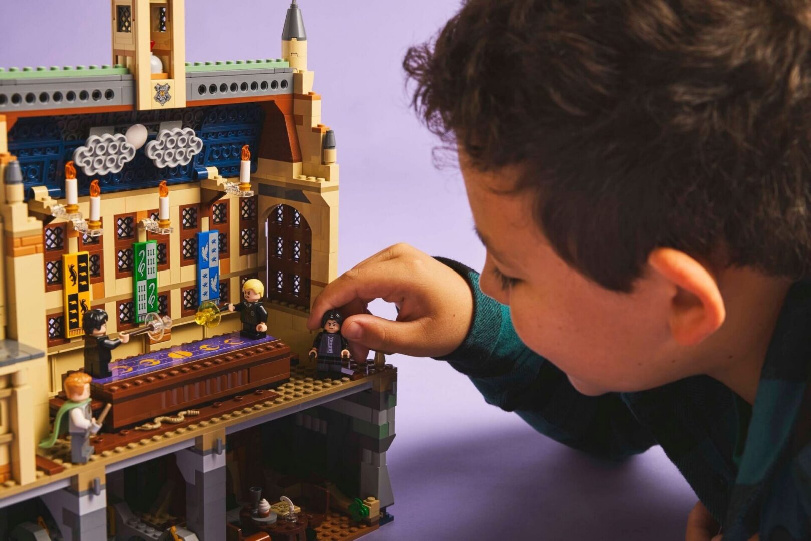 Child playing with Hogwarts LEGO set