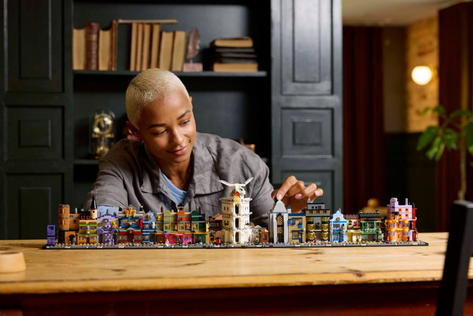 Person assembling colorful building model